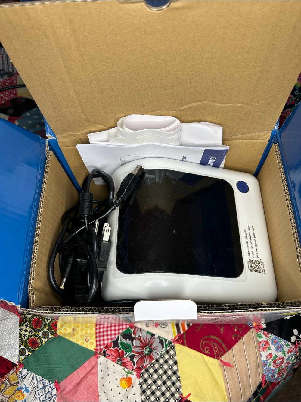 Jade White Compact Device with Black Screen and Blue Button